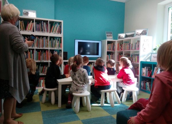 Dzieci słuchają prezentacji i oglądają start rakiety