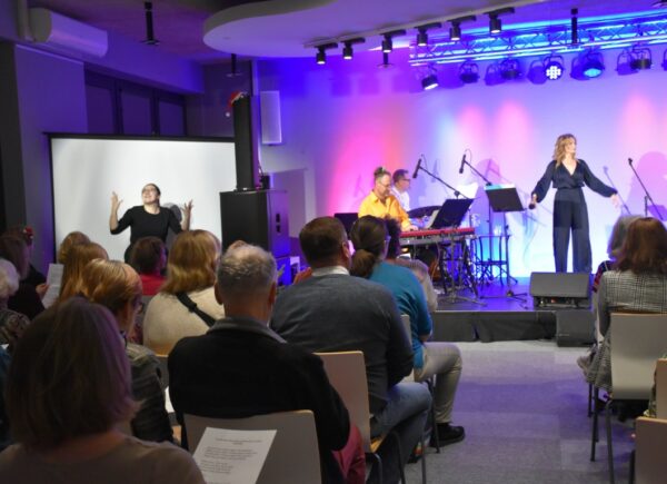 Anna Sroka-Hryń z zespołem na scenie przed publicznością podczas koncertu świątecznego "Lulejże, mi lulej"